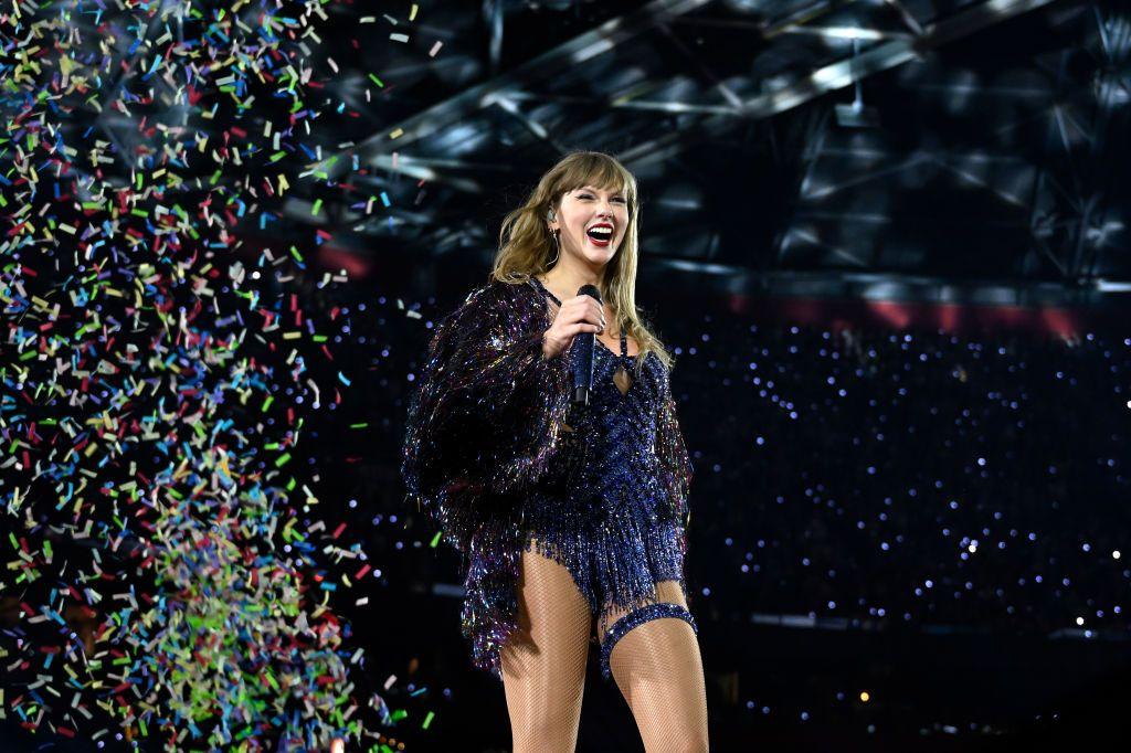 Taylor Swift on stage at the Era's tour, as confetti explodes around her