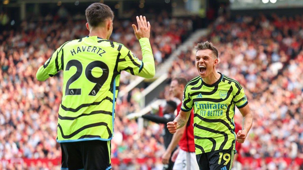 Leandro Trossard and Kai Havertz celebrate the Belgian's goal at Old Trafford