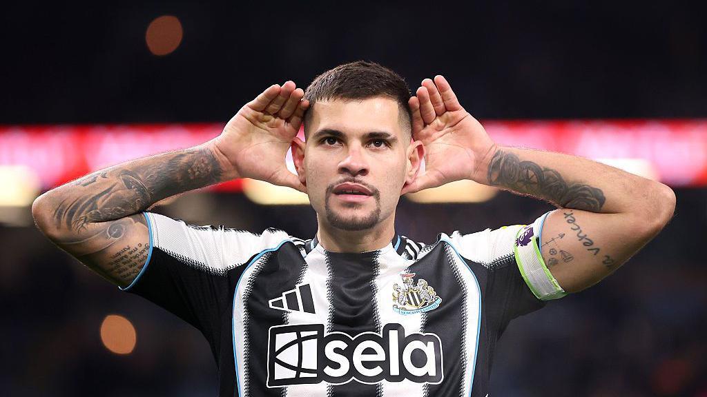 Bruno Guimaraes cups his ears