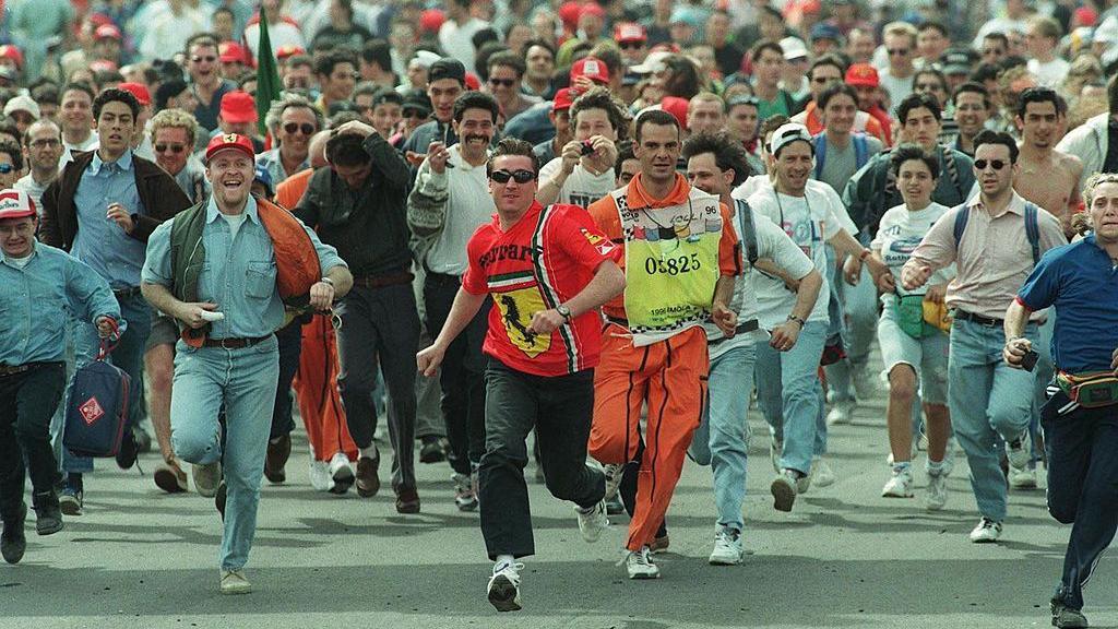 Fans rush to see the podium celebrations following the 1996 San Marino Grand Prix 