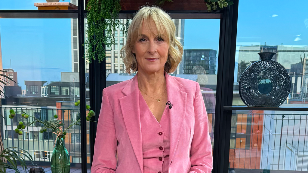 Rip Off Britain's Louise Minchin sat in the Morning live studio wearing a pink waistcoat and pink suit jacket, she has curled blonde hair with a fringe that reaches just above her eyes. She is wearing a gold necklace around her neck.