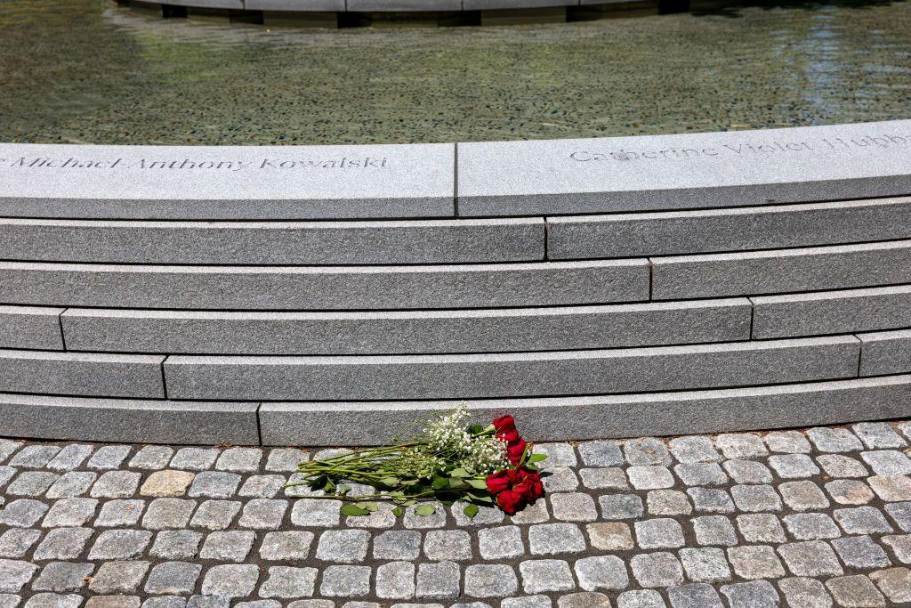 A bouquet of flowers next to a stone fountain, a memorial to the victims of the Sandy Hook Elementary School shooting