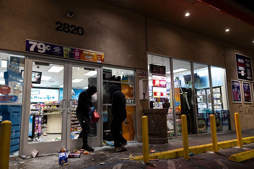 Looters break into a petrol station's market place in the Compton neighbourhood of Los Angeles on 8 June 2025