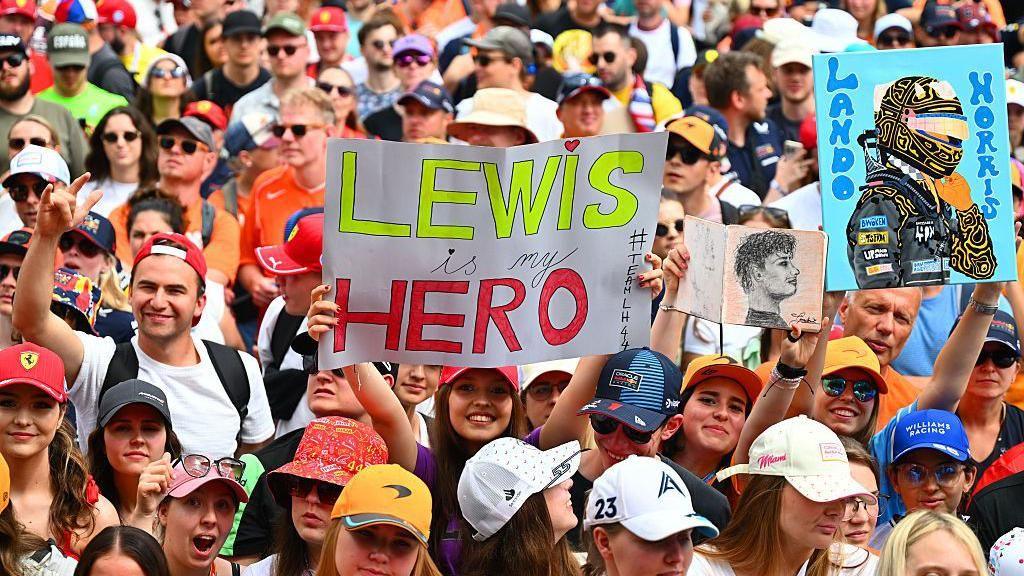 Fans hold up signs for Lewis Hamilton and Lando Norris in Austria 