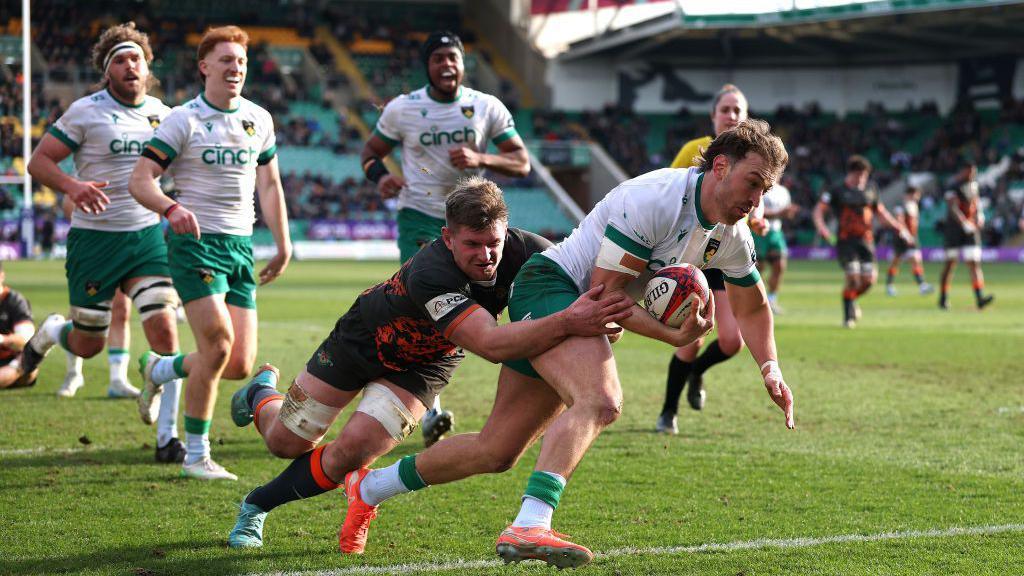 James Ramm dives over the line despite being tackled