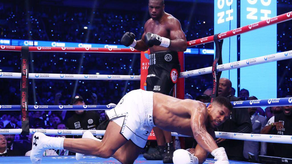 Anthony Joshua crashes to the canvas with Daniel Dubois standing over him