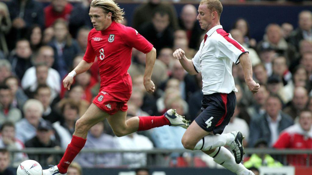 England's Nicky Butt chases Wales' Craig Bellamy