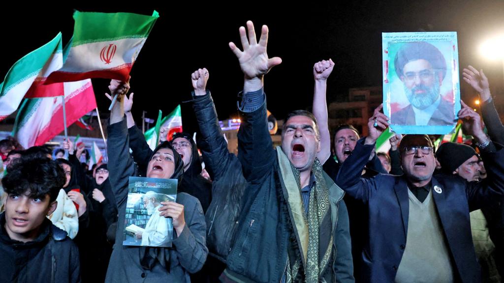 Iranians react after a ceasefire announcement at the Enqelab square, in Tehran, on April 8 2026.