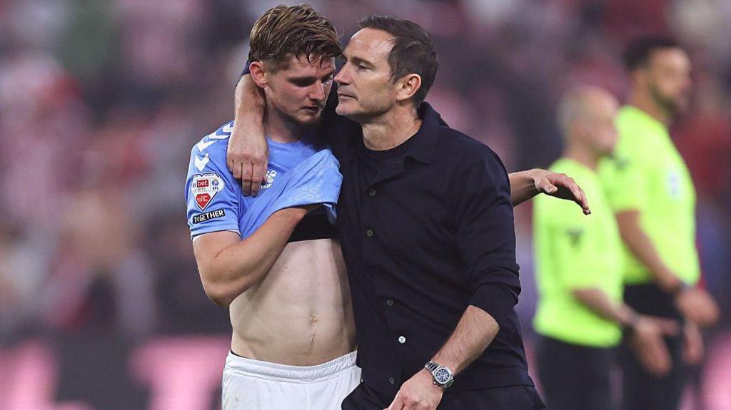 Jack Rudoni wipes the tears away from his face with his Coventry City shirt as head coach Frank Lampard puts a consoling arm around him after the club's play-off defeat by Sunderland
