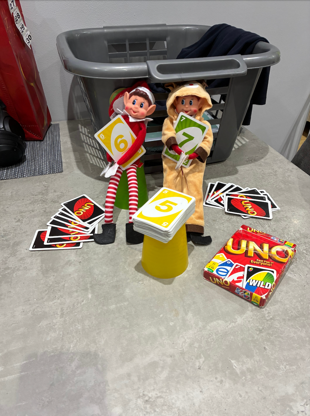 Elves seen holding uno cards that show numbers 6 7 