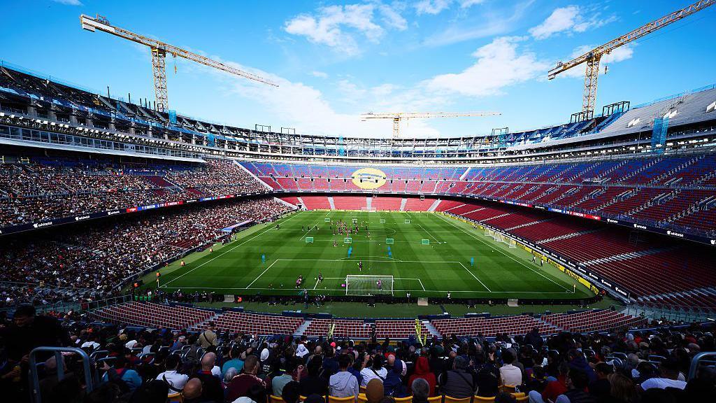 General view of the stadium with Barcelona players during an open training session at the Nou Camp 