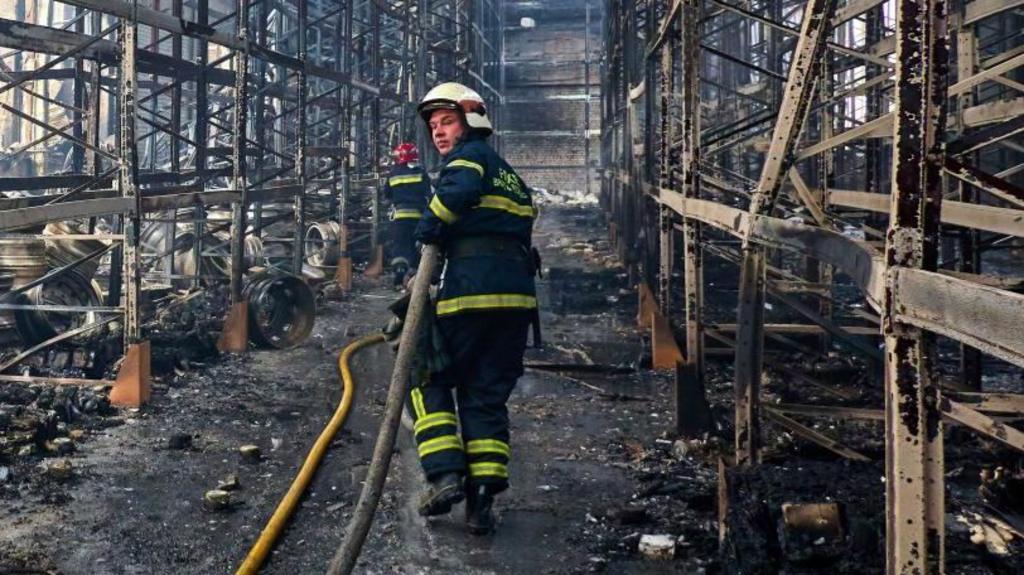Firefighter at a damaged storage facility of a private factory in Kharkiv, Ukraine.