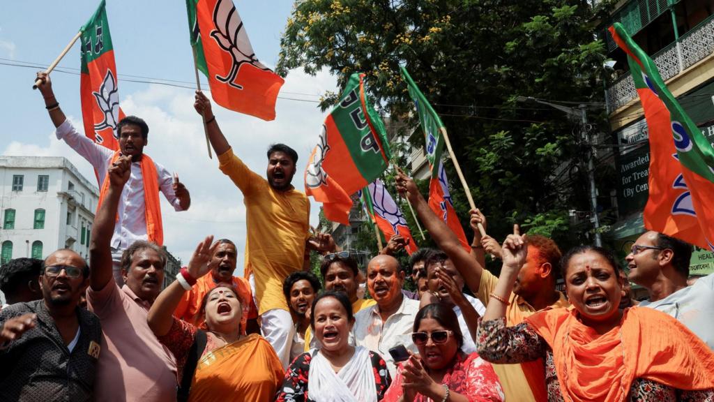 India's ruling Bharatiya Janata Party (BJP) supporters celebrate as early trends show their party leading in the West Bengal state assembly election results, outside the party's regional office in Kolkata, India, May 4, 2026. 