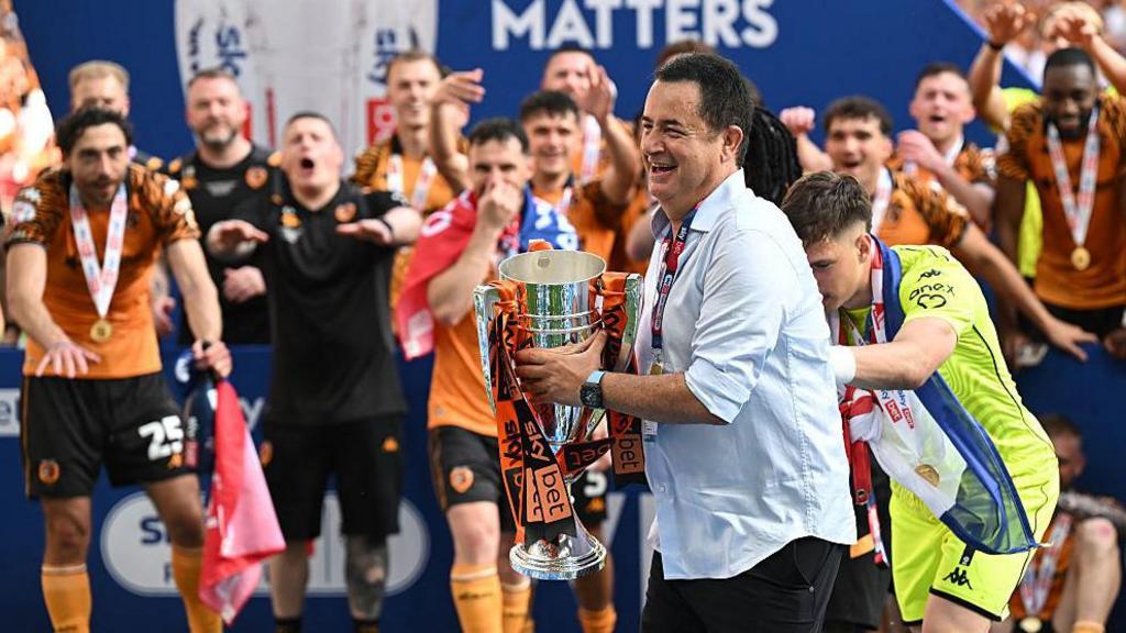 Hull City's Turkish owner Acun Ilicali celebrates with the trophy after the English Championship play-off final football match between Hull City and Middlesbrough