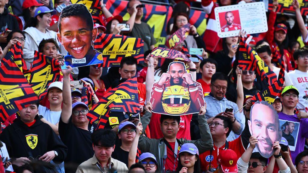 Fans hold up signs for Lewis Hamilton at the Chinese Grand Prix