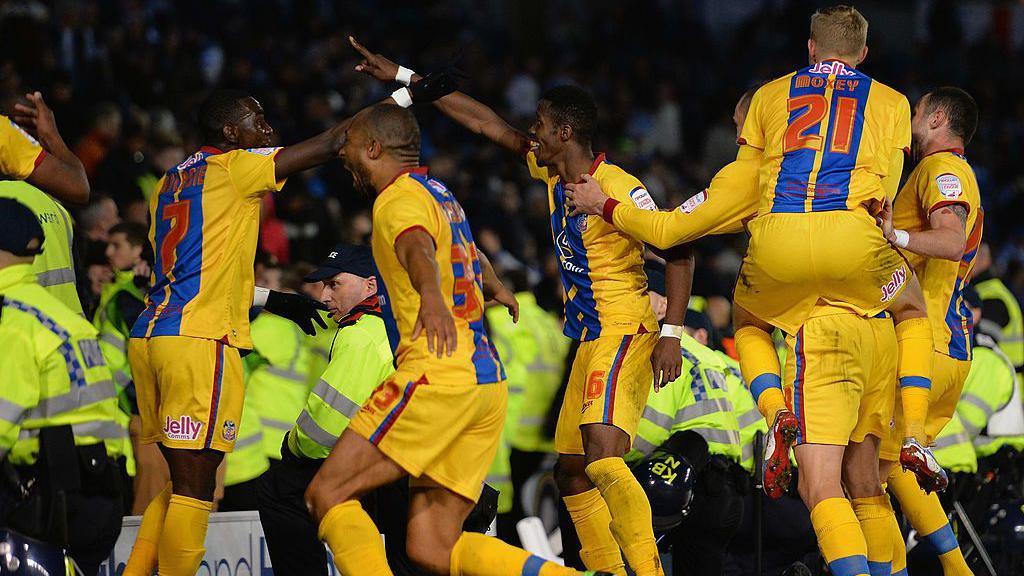 Wilfried Zaha of Crystal Palace celebrates his second goal amongst the police during the npower Championship play off semi final second leg between Brighton & Hove Albion and Crystal Palace at Amex Stadium on May 13, 2013