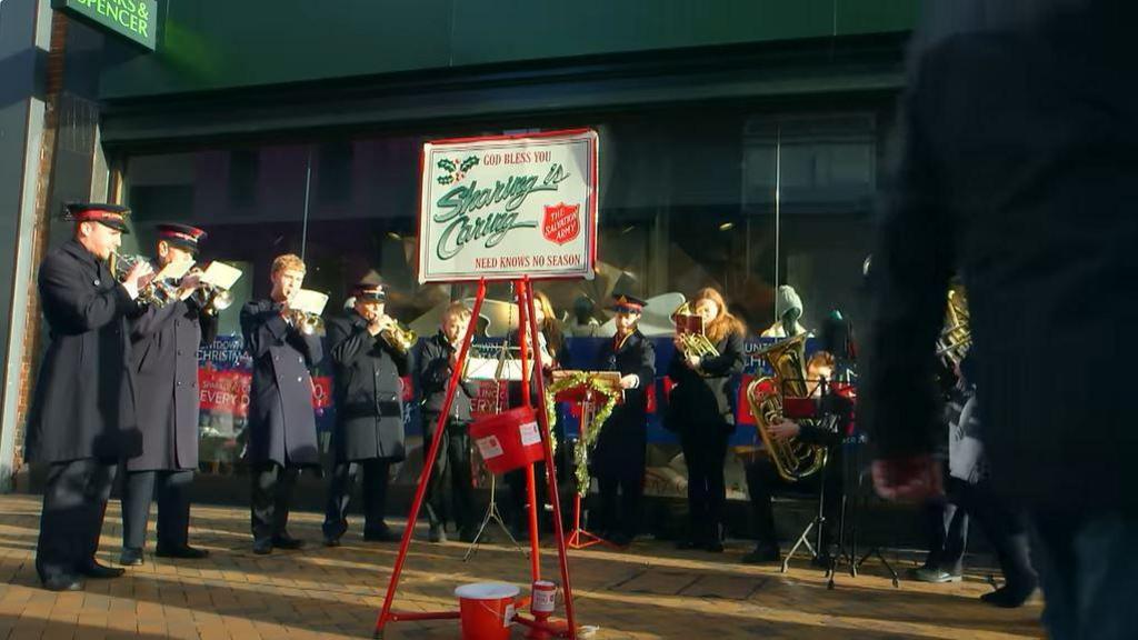 A snippet of the band from the holding trumpets and stood around playing music in the 2015 music video.