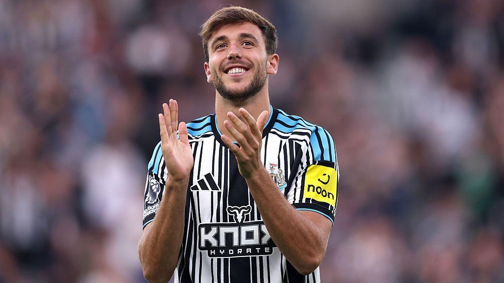Nico Gonzalez applauds the Newcastle fans after being unveiled before their Carabao Cup against West Brom