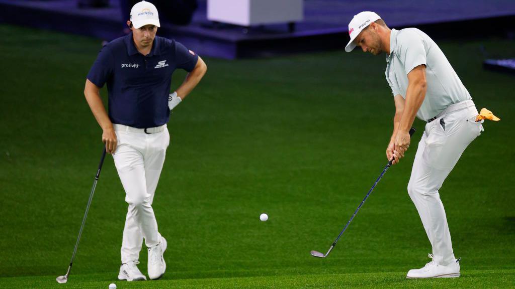 Players hit chips to the green at the TGL