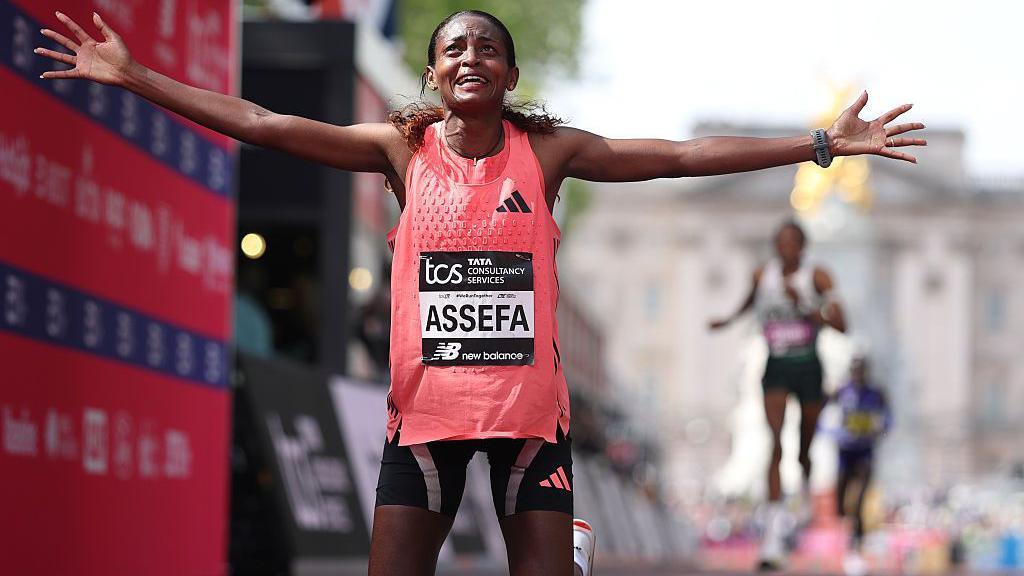 Tigst Assefa crossing the line.