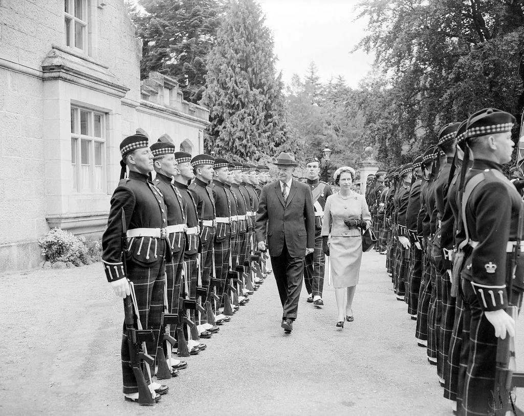 President Dwight D Eisenhower with Queen Elizabeth as he inspects a guard of honour from the Royal highland Fusiliers at the entrance to Balmoral Castle. 28th August 1959. (Photo by Daily Herald/Mirrorpix via Getty Images)