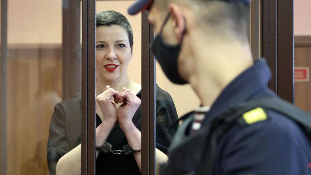 Maria Kolesnikova, the last remaining protest leader still in Belarus, gestures making a heart shape inside the defendants' cage during her verdict hearing on charges of undermining national security, conspiring to seize power and creating an extremist group, on September 6, 2021 in Minsk.