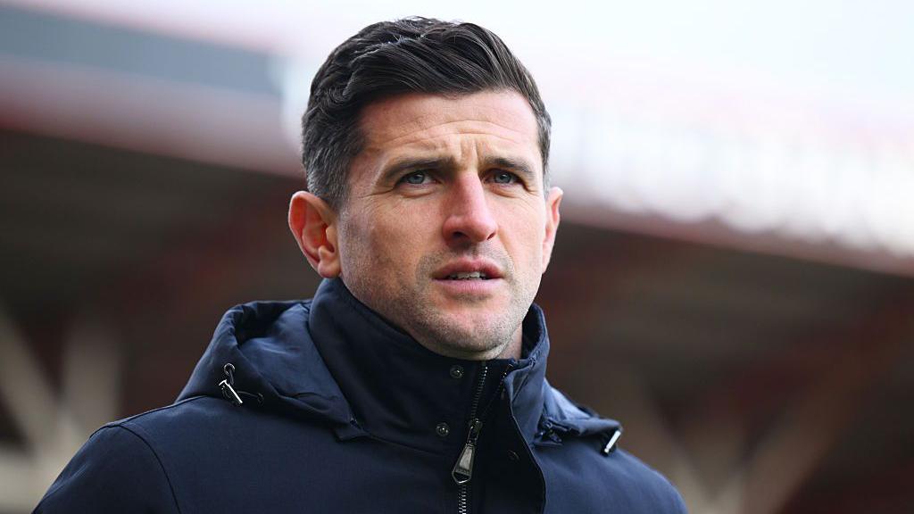 John Mousinho, manager of Portsmouth, looks on prior to the Championship match between Bristol City and Portsmouth at Ashton Gate