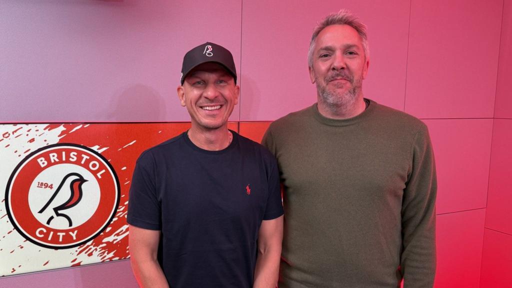 Gerhard Struber and Ed Hadwin stood in a red studio