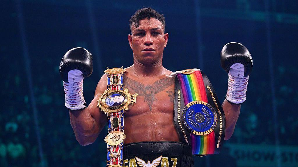 Bilal Fawaz poses with his British and Commonwealth light-middleweight belts 