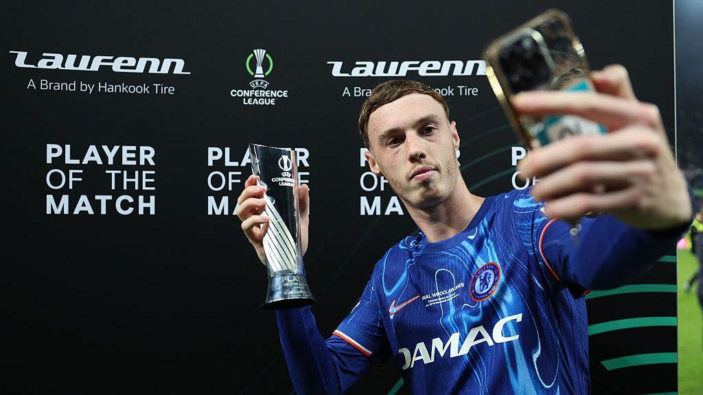 Cole Palmer taking a selfie with the Player of the Match award.