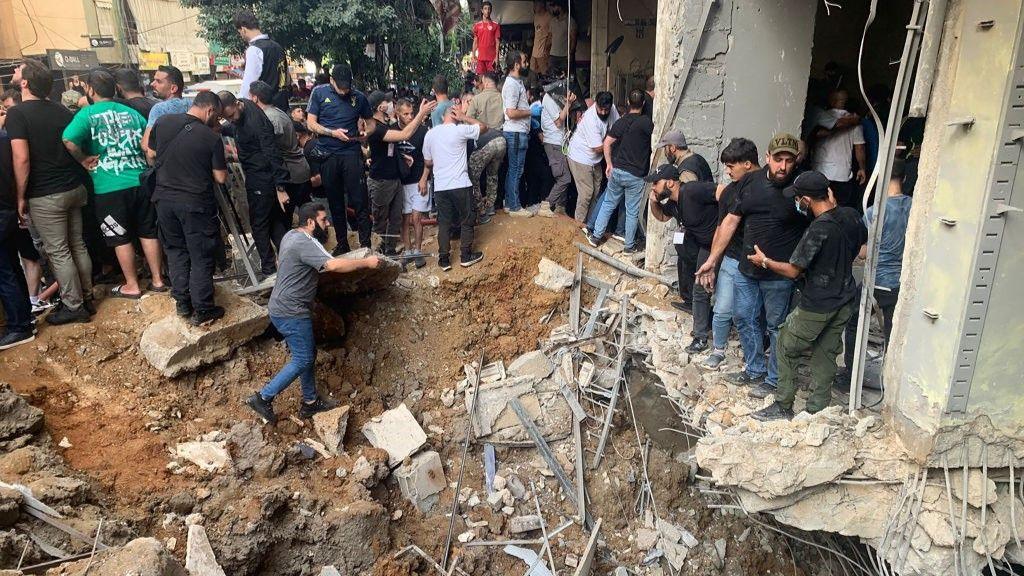 People check the damage following an Israeli strike in Beirut's southern suburbs 