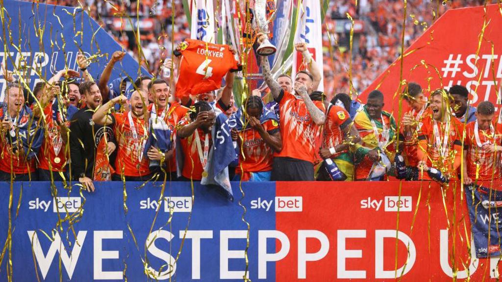 Luton Town's players celebrate their Championship play-off final victory over Coventry City in 2023.