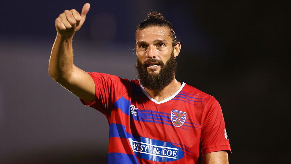 Andy Carroll holds a thumbs up signal