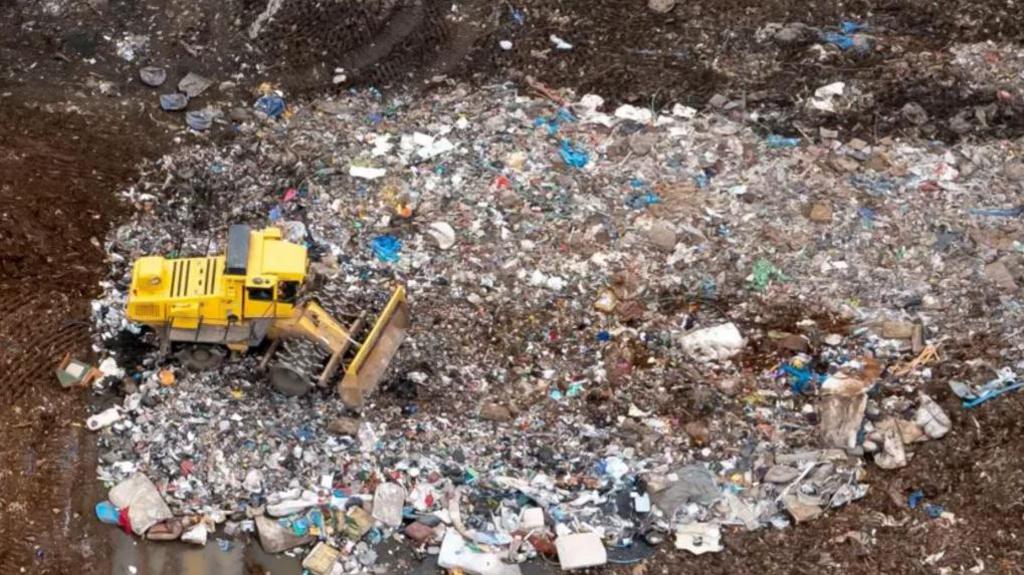 Landfill site with yellow JCB