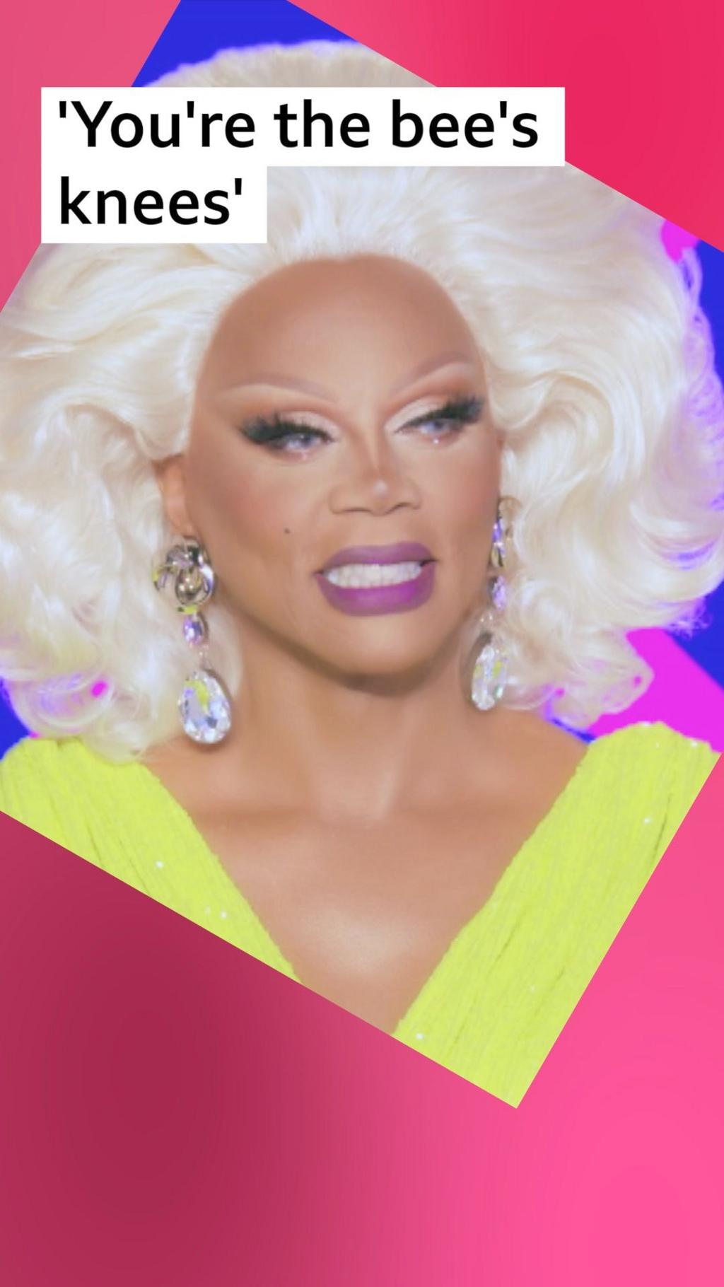 Drag queen, RuPaul, smiles - he has a blond wig and wears a yellow dress