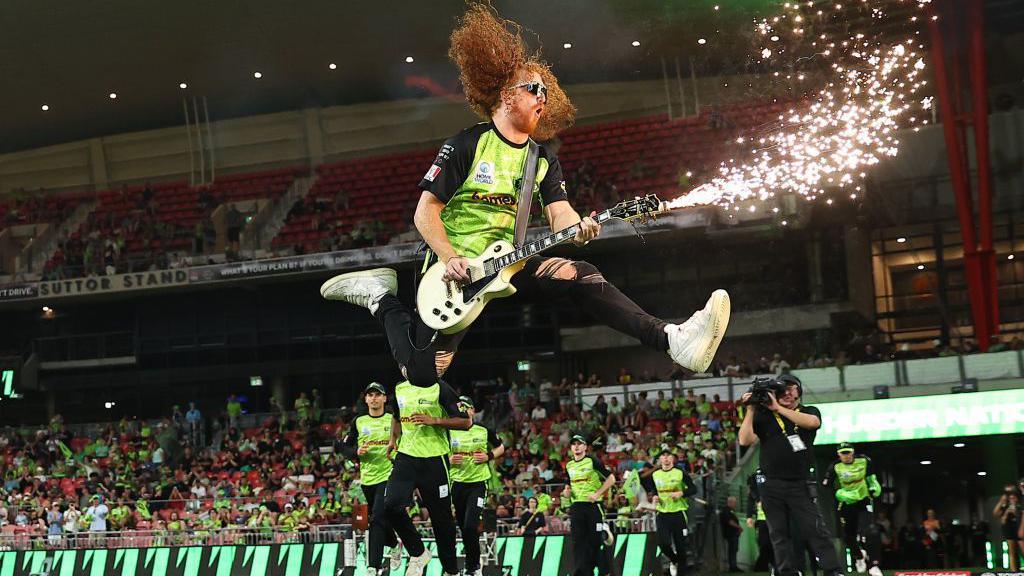 A guitarist performs during the BBL match between Sydney Thunder and Perth Scorchers at ENGIE Stadium in Sydney, Australia