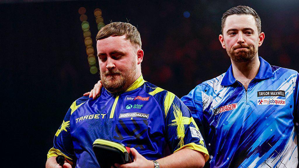 Luke Littler and Luke Humphries looking on