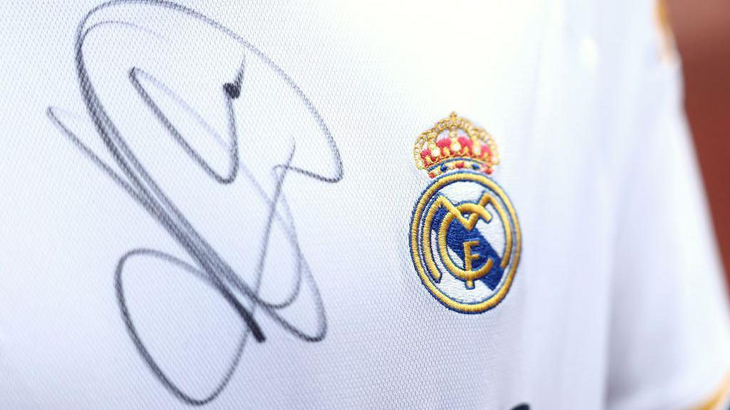 A close up image of a Real Madrid shirt signed by Kylian Mbappe