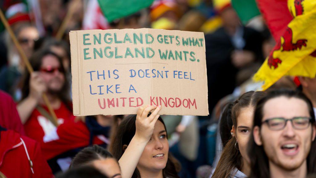 Holding a sign in a march