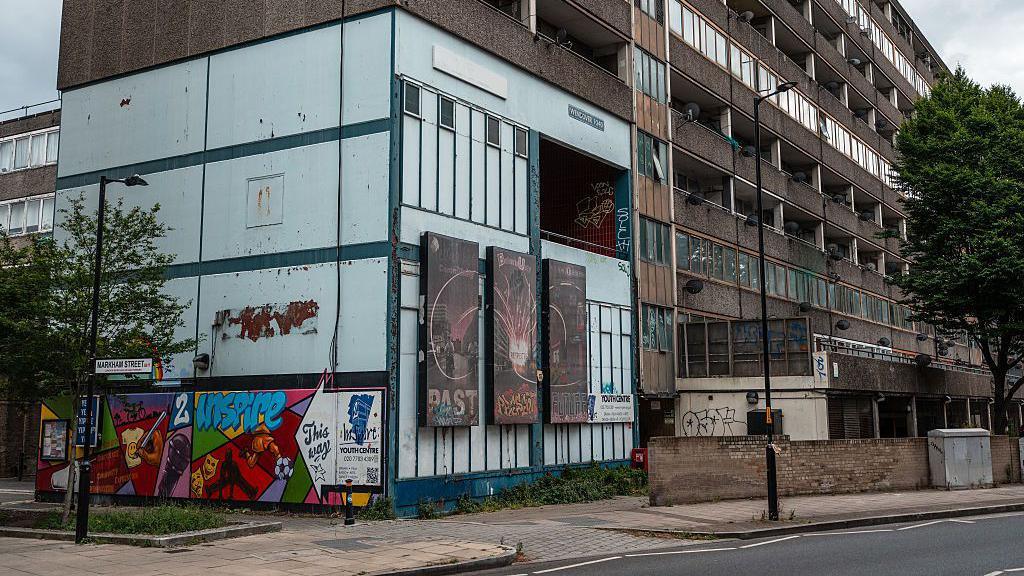 A residential tower block stands empty on the Aylesbury Estate in London