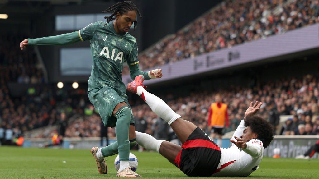 Djed Spence tackles Willian during Spurs v Fulham