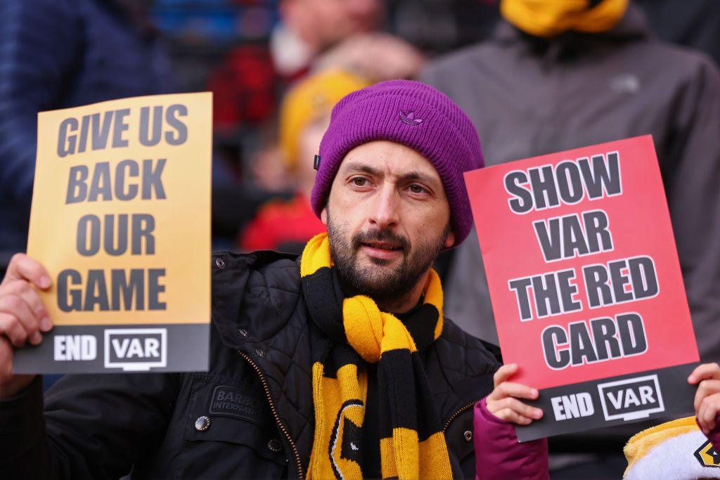Wolves fans holding anti VAR signs