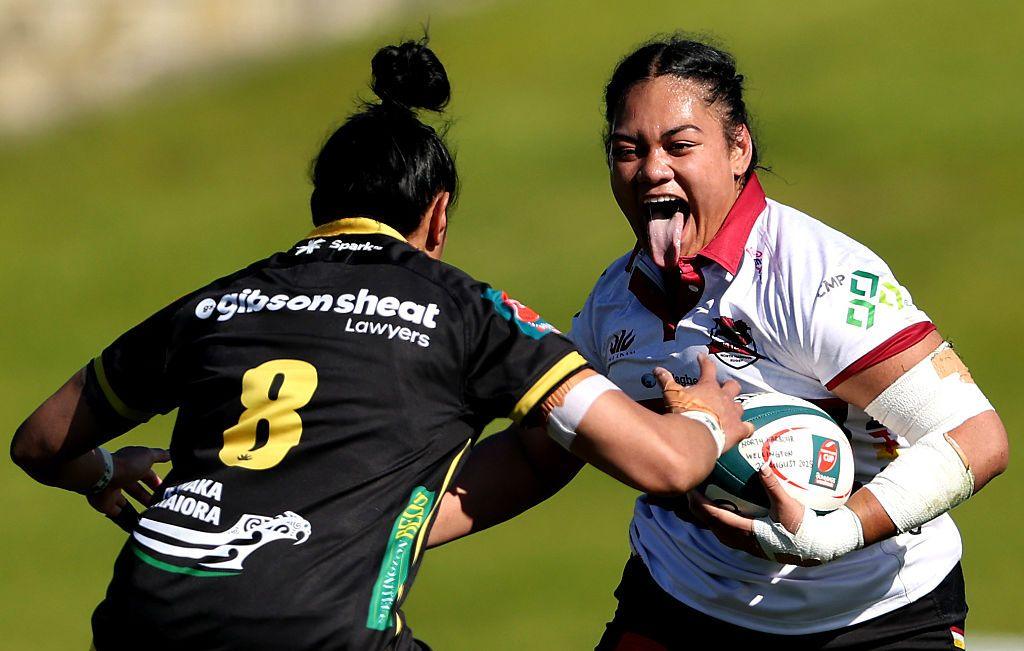 North Harbour's Rialani Onesemo-Tuilaepa makes a break to be tackled by Wellington's Jackie Patea-Fereti during the round three Farah Palmer Cup match between North Harbour and Wellington at North Harbour Stadium in Auckland, New Zealand. Photo by Phil Walter