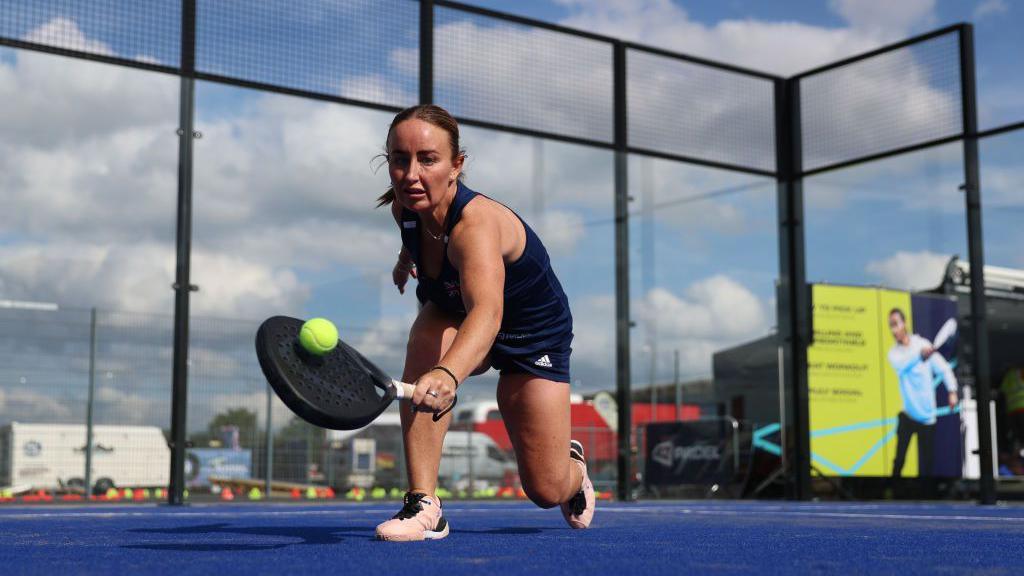 Aimee Gibson plays a shot at the F1 British Grand Prix event at Silverstone