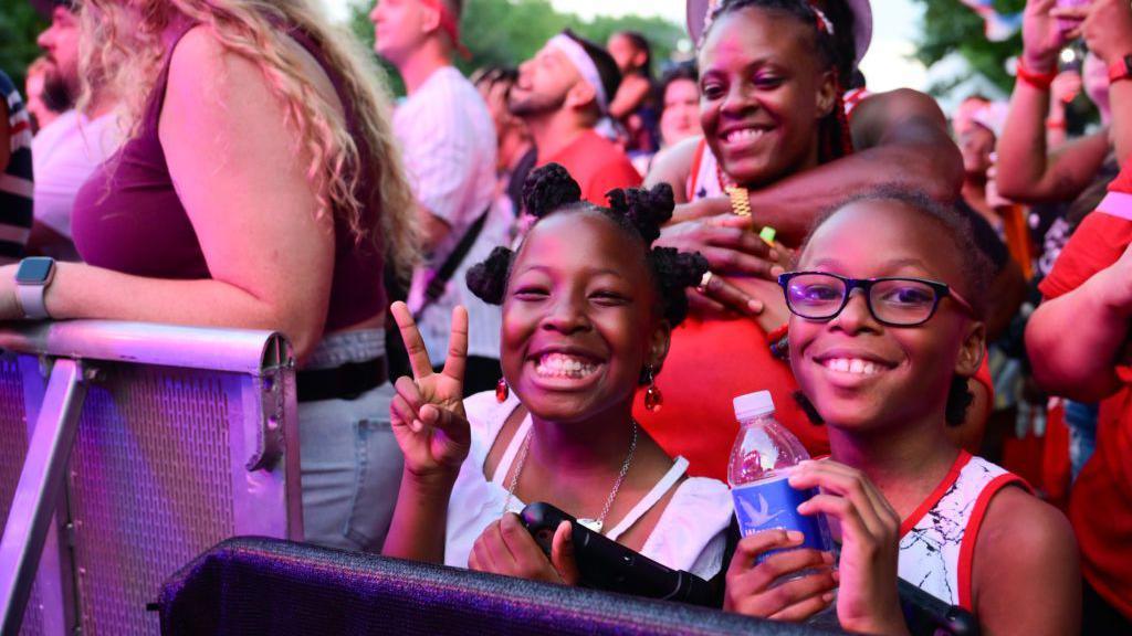Two young girls enjoying the Wawa Welcome America concert in Philadelphia.