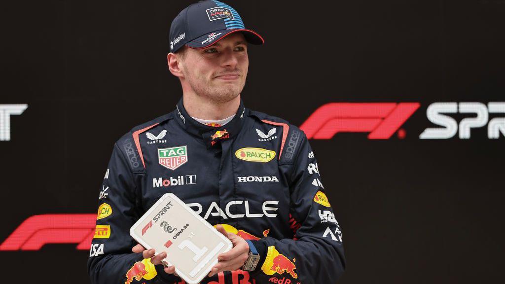 Max Verstappen holds up a medal after winning the sprint race in China last year 