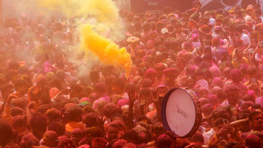 Street in India full of people celebrating Holi 