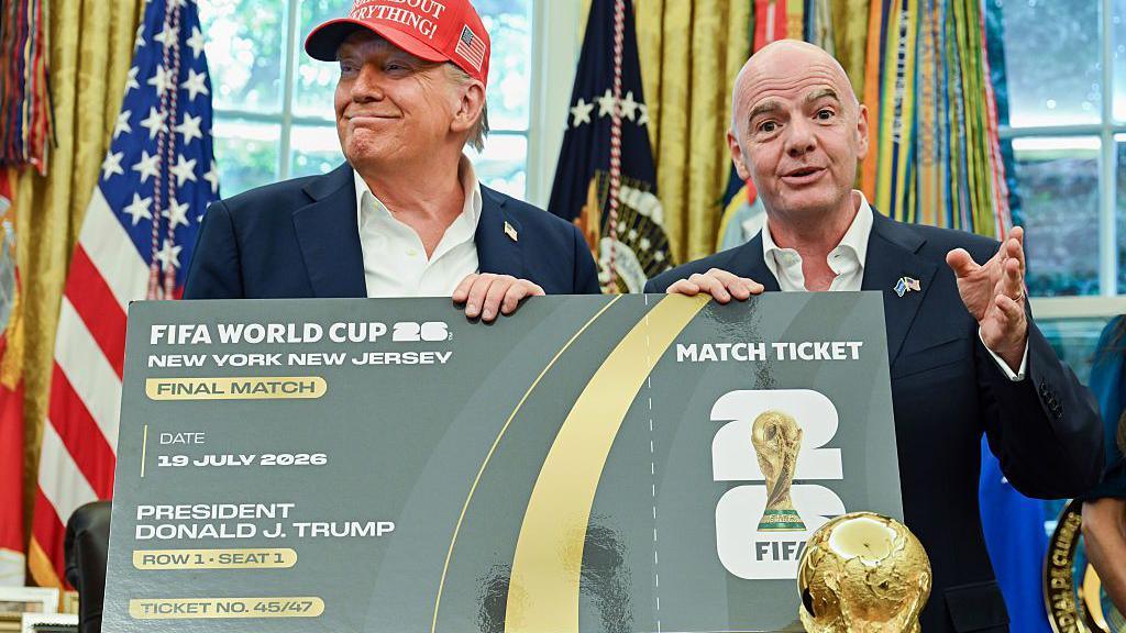 US President Donald Trump, left, and Gianni Infantino, president of FIFA, hold a novelty ticket to the final 2026 World Cup final