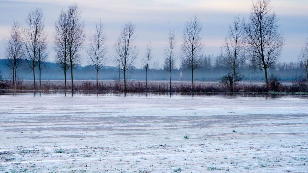 A lake iced over in cold weather.