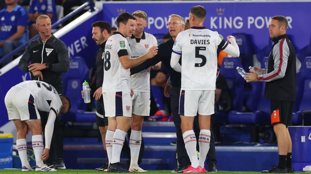 Nigel Adkins [centre] talks to his Tranmere Rovers players on the touchline